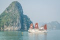 A tourist boat cruising on the waters of Ha Long Bay in Vietnam Royalty Free Stock Photo