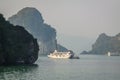 A tourist boat cruising on the waters of Ha Long Bay in Vietnam Royalty Free Stock Photo