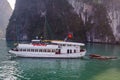 A tourist boat cruising on the waters of Ha Long Bay in Vietnam Royalty Free Stock Photo