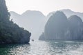 A tourist boat cruising on the waters of Ha Long Bay in Vietnam Royalty Free Stock Photo