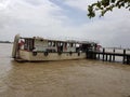 Tourist boat docked on the Suriname river along the waterfront in Paramaribo Suriname.