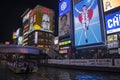 Tourist boat in Dotonbori Canal and famous Glico Running Man sig