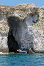 Tourist boat entering a sea cave