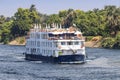 A Tourist boat motor down the River Nile towards Aswan in central Egypt. The tourist boats cruise between Luxor and Aswan in Royalty Free Stock Photo