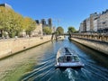 Tourist boat on the Seine just west of Notre Dame on a sunny October day, Paris, France