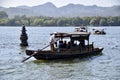 Tourist Boat near a Floating Stone Pagoda on The West Lake. Hangzhou, Zhejiang, China. October 28, 2018.