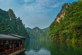 Tourist boat sailing among karst landscape on Baofeng Lake