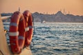 Tourist boat sails on the Golden Horn in Istanbul at sunset Royalty Free Stock Photo