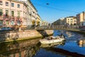 Tourist boat sails under the Bank bridge with griffins on the Griboyedov canal. Saint-Petersburg.