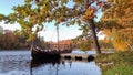 The Tourist Boat in the Style of a Viking Ship on the River Perse. Autumn Old Koknese Castle Ruins. Royalty Free Stock Photo