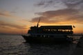 Tourist boat with sunset background