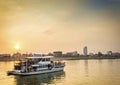 Tourist boat on sunset cruise in phnom penh cambodia river Royalty Free Stock Photo