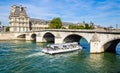 A tourist boat and tourists near Flora Pavilion ot the Louvre