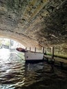 Tourist boat under bridge