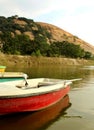 The fiber boats in the lake with hills at sittanavasal cave temple complex.