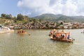 Tourist boating on traditional decorative boat in the scenic lake of Ban Rak Thai, a beautiful village within Mae Hong