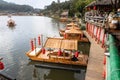 Tourist boating on traditional decorative boat in the scenic lake of Ban Rak Thai, a beautiful village within Mae Hong