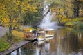 Tourist boats Autumn park in the center of Riga with fountain , Latvia Canal that flows through Bastion park autumn