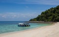 Tourist boats moored on a beach on the tropical island of Pulau Tulai, Malaysia Royalty Free Stock Photo