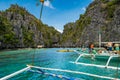 Tourist boats moored in a tranquil bay on turquoise waters of Sulu Sea. Royalty Free Stock Photo