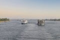 Tourist boats on the Nile river near Aswan. A fleet of floating hotels tourist boats motor down the River Nile towards Aswan in