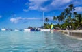 Tourist boats off the coast of the Caribbean Sea. The beach of the island Saona in cloudy weather. Rainbow over the island Royalty Free Stock Photo