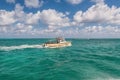 Tourist boats sail to the wild Stingray city on Gran Cayman island, BWI Royalty Free Stock Photo