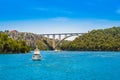 Tourist boats and Sibenik bridge over Krka River in Krka National Park, Croatia. River and two mountains on a sunny day