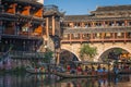 Tourist boats under arched bridge in Feng huang Old Town