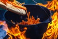 Tourist bowler with food on bonfire, cooking in the hike, outdoor activities. Preparation of pilaf. Royalty Free Stock Photo