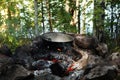 Tourist bowler with food on the campfire