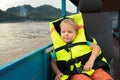 Tourist boy enjoy boat trip. Laos.