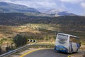 Tourist bus carries travelers by the mountain road to the Golan Heights, Israel