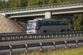 Tourist bus moves along the highway junction under the bridge Royalty Free Stock Photo