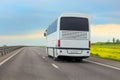 Tourist bus moves along a suburban highway Royalty Free Stock Photo