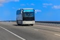 Tourist Bus Moves Along Suburban Highway Royalty Free Stock Photo