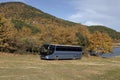 The tourist bus is parked in the forest near the lake Royalty Free Stock Photo