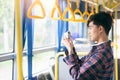 Tourist on the bus taking a photo of the city.