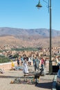 Tourist buys souvenirs from Arab man in Boumalne Dades.Morocco. October 2019