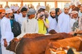Tourist with camera among Arabs at the famous goat market in Nizwa, Oman, Asia