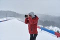 Tourist with camera in the blizzard Royalty Free Stock Photo