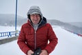 Tourist with camera in the blizzard Royalty Free Stock Photo