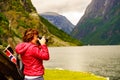 Tourist with camera near old viking boat, Norway Royalty Free Stock Photo