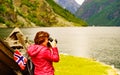 Tourist with camera near old viking boat, Norway Royalty Free Stock Photo