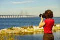 Tourist with camera and Oresund bridge Sweden Royalty Free Stock Photo