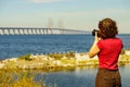 Tourist with camera and Oresund bridge Sweden Royalty Free Stock Photo