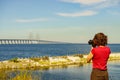 Tourist with camera and Oresund bridge Sweden Royalty Free Stock Photo