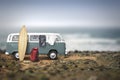 Tourist camp with bags, surfboard and car