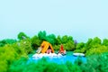 Plasticine landscape with a tent, a campfire and a backpack in the middle of the forest