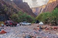 Tourist camp with tents and cars in a unique natural canyon with bottle trees on the slopes.